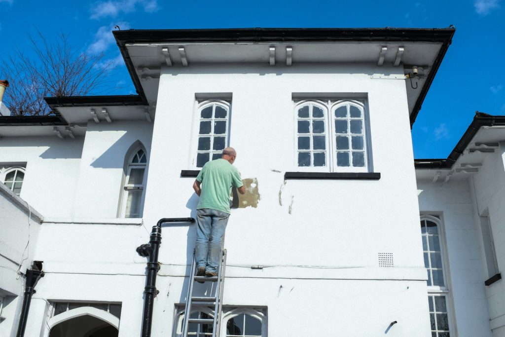 Reformas Mansan 2021 man in yellow shirt and blue denim jeans standing on white concrete building during daytime